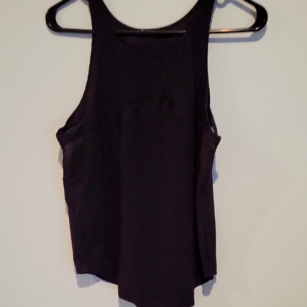 Black Asymmetrical Cut Out Tank Top. Missing Tag . It can fit A Medium